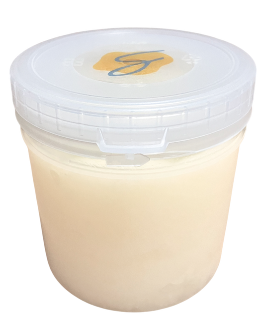 A clear plastic tub filled with a pale creamy beige pure coconut oil, mainly for making popcorn, sealed with a translucent white lid that has a small yellow and blue logo in the center, isolated on a black background.